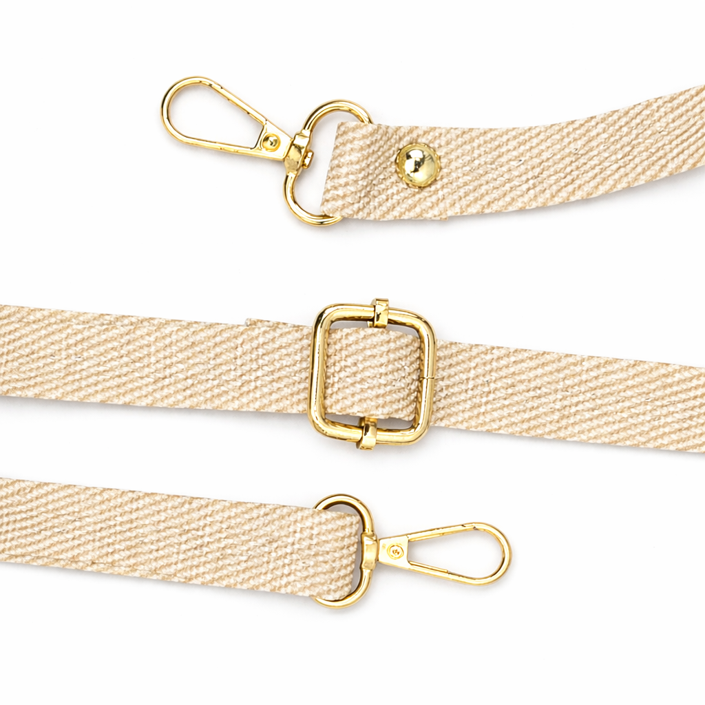 Beige strap with gold hardware on a white background