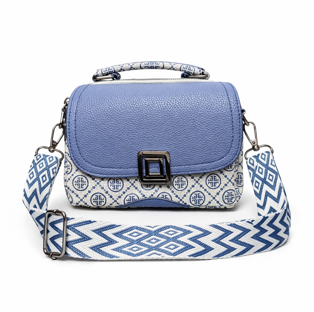 Blue handbag with a patterned strap on a white background