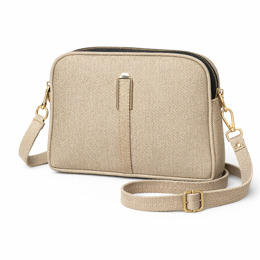 Beige crossbody bag with gold accents on a white background