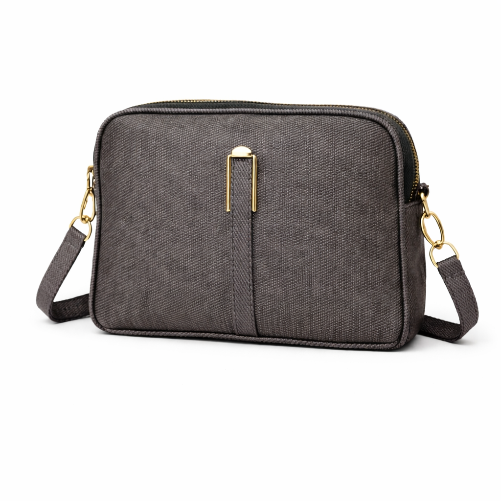 black crossbody bag with gold accents on a white background