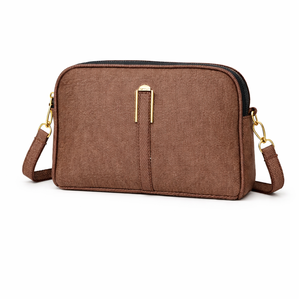 Brown crossbody bag with gold accents on a white background