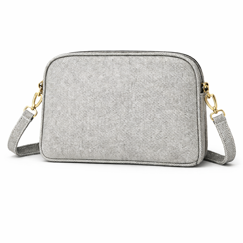 Gray crossbody bag with gold accents on a white background