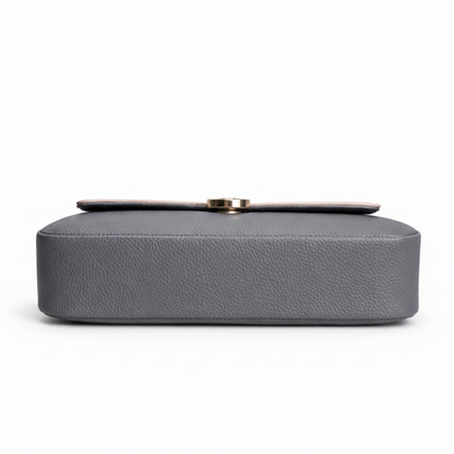 Gray handbag with a gold clasp on a white background
